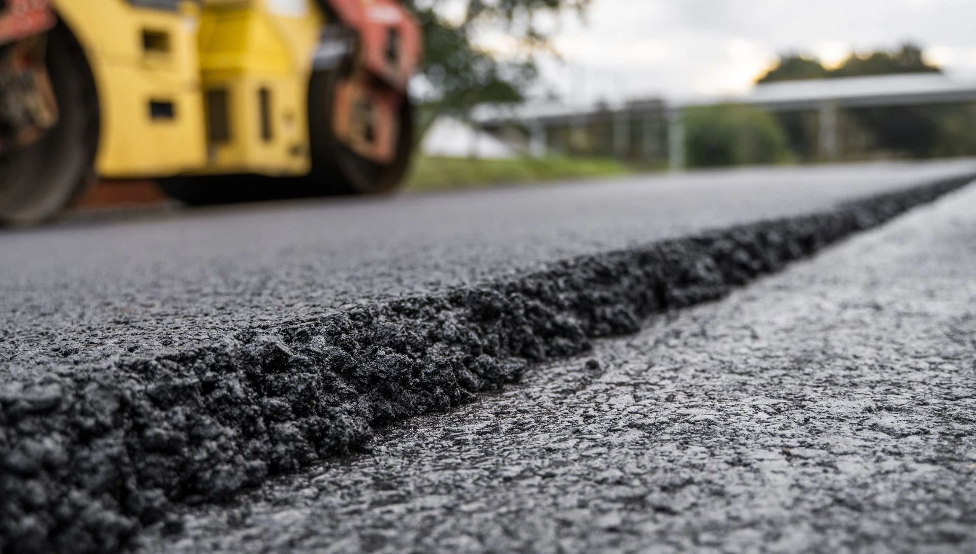 A road-level shot of asphalt being applied.