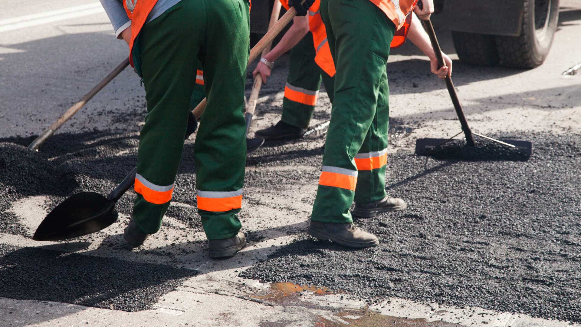 Workers Resurfacing Road