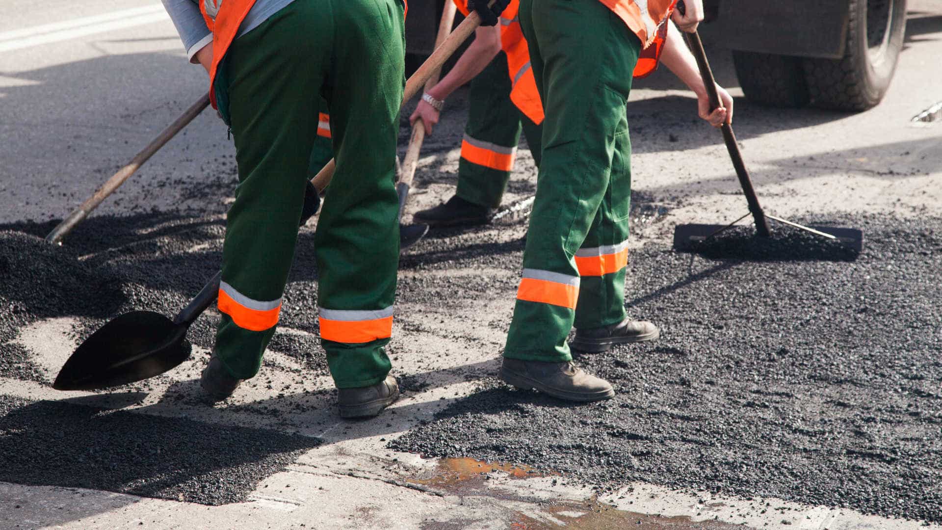 Workers resurfacing road