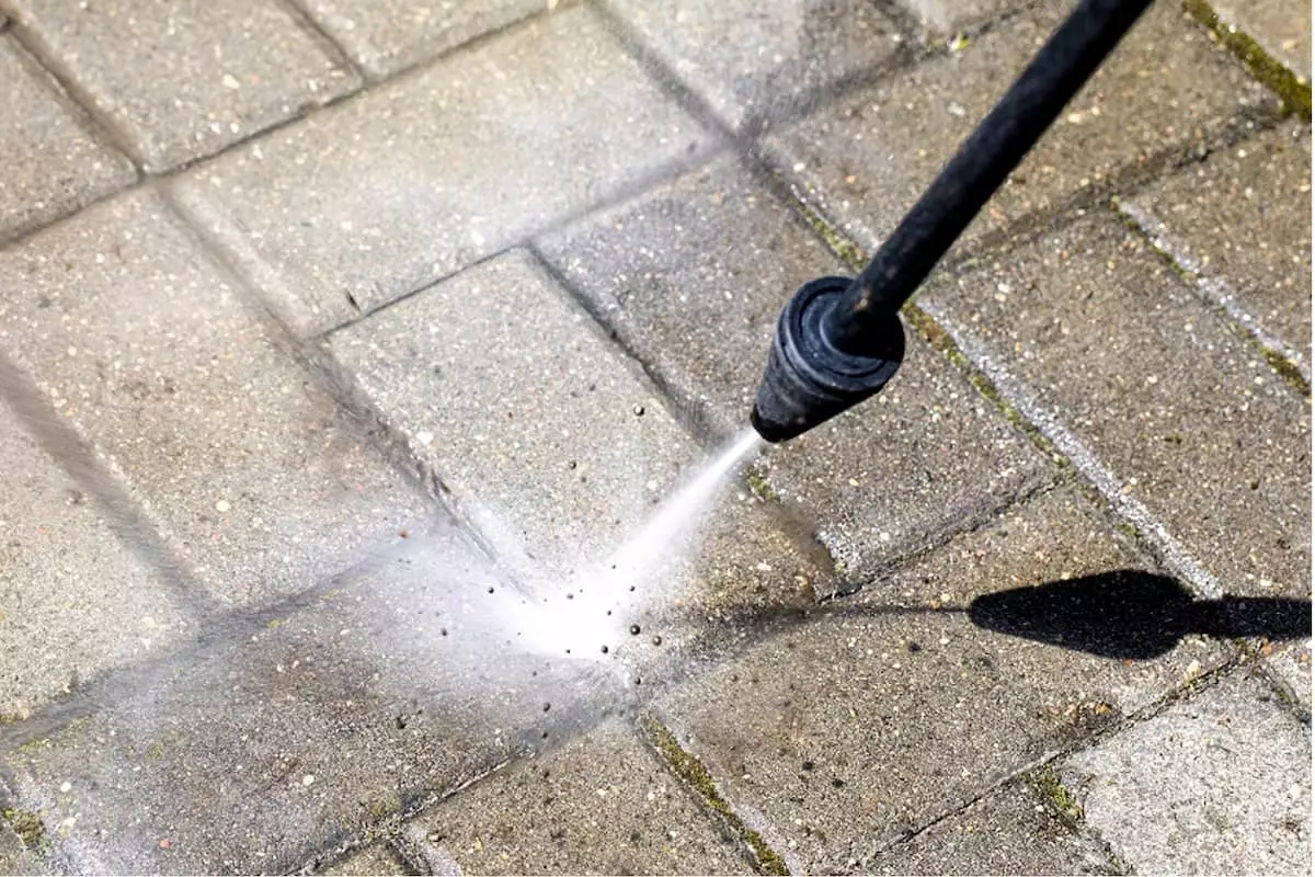 Close-up of a waterblaster being used on concrete