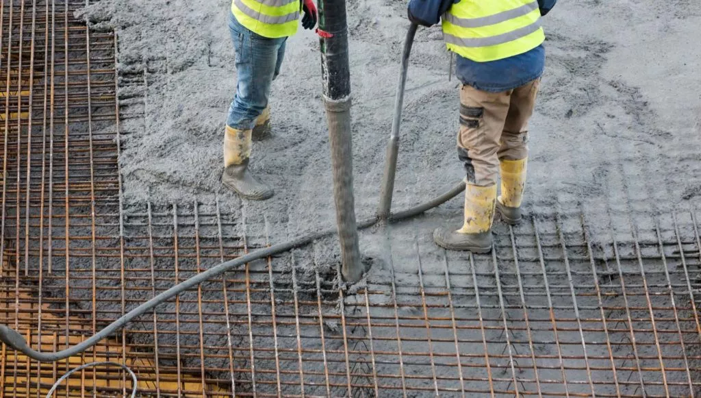 a traffic engineering crew using steel to reinforce self-healing concrete